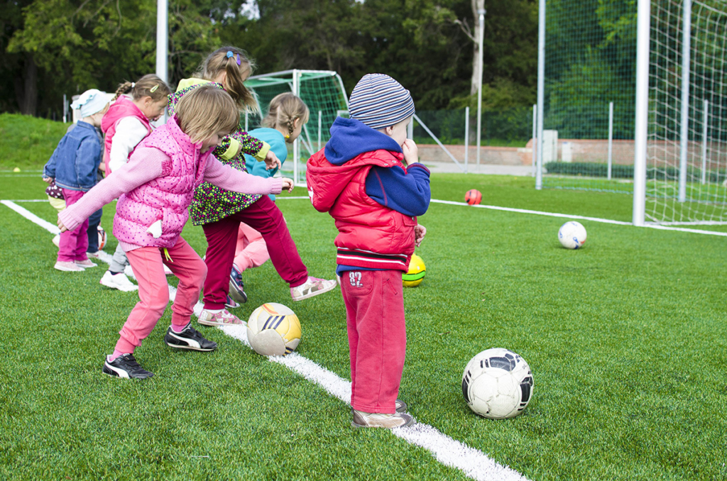 Preschoolers enjoy playing football