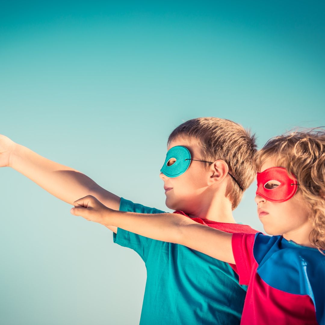 children dressed in superhero costumes