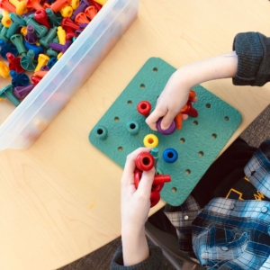 child playing with fine motor toy