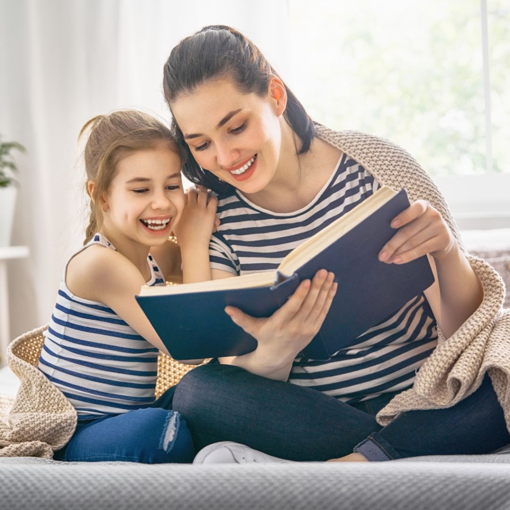 A daughter and mother reading and laughing together