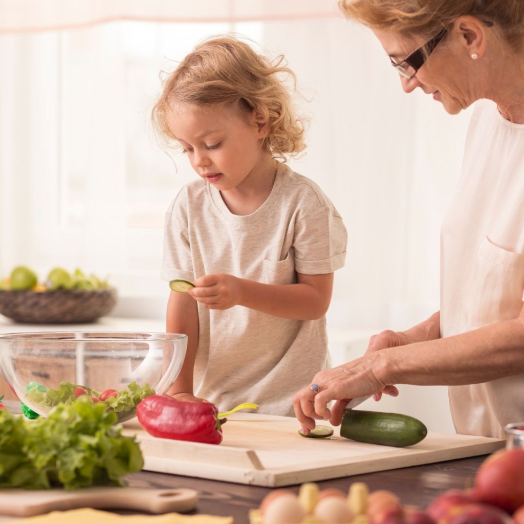 Child cooking in kitchen with mom