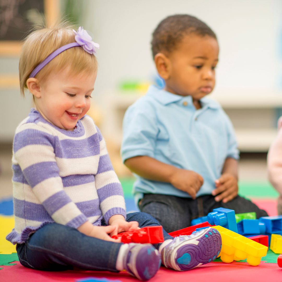two smiling children sitting together