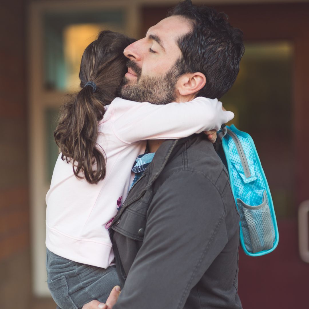 father hugging daughter