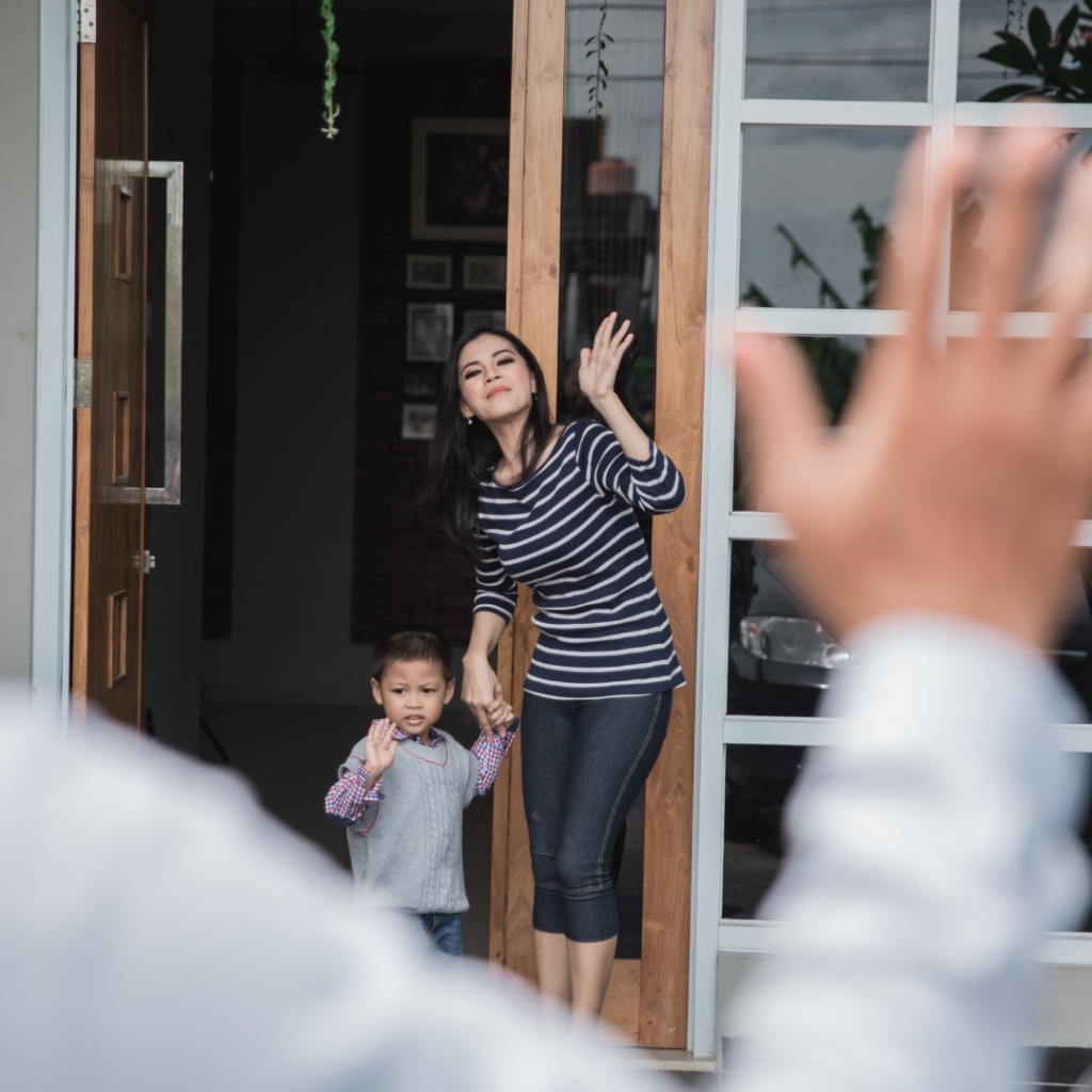parent waving goodbye to child dropped off at daycare