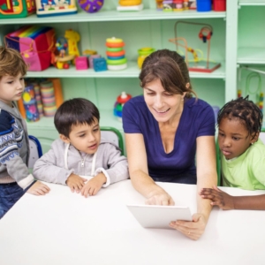 Preschoolers with teacher and tablet