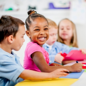 girl smiling at her table