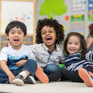 three kids smiling and laughing together