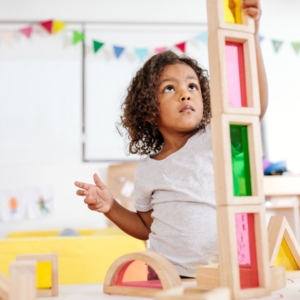 a little girl stacking blocks
