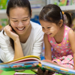 a mom reading to her daughter