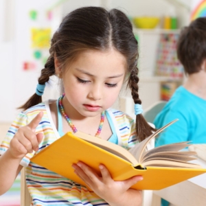 little girl reading book