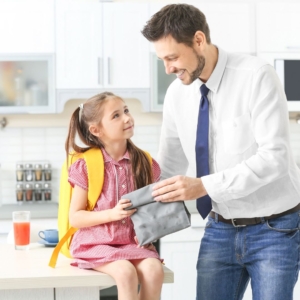 girl getting ready for school with her dad