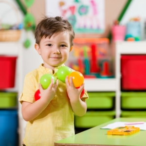 Young boy holding toys