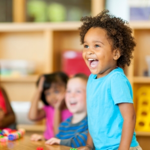 Young girl laughing in preschool